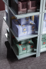 Retail packaging for AVOLT Square 1 and Square 2 power extenders on metal shelving