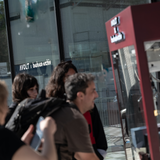 Crowd at bauhaus-archiv with AVOLT x bauhaus-archiv decal on glass, blurred visitors in the foreground